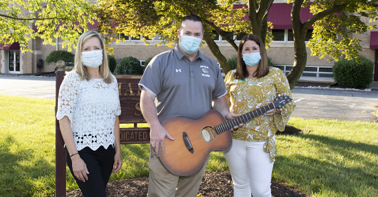 WSFS Associates and Anthony Penna Charitable Fund representative, holding a guitar.