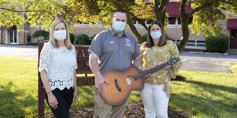 WSFS Associates and Anthony Penna Charitable Fund representative, holding a guitar.