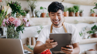 A florist looking at his tablet.