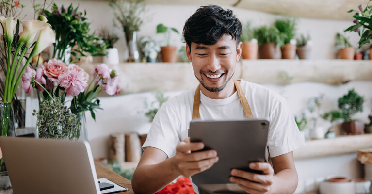 A florist looking at his tablet.