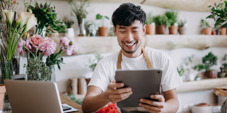 A florist looking at his tablet.