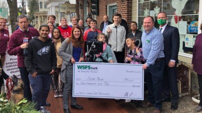 Pride Paws staff and WSFS Associates holding a prop check for $1000.
