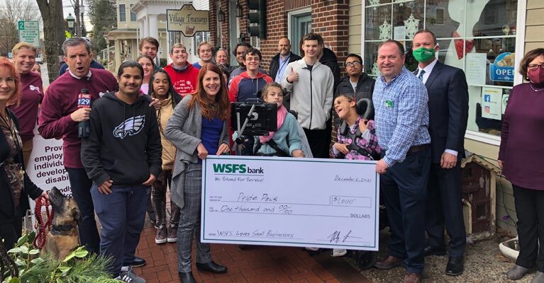 Pride Paws staff and WSFS Associates holding a prop check for $1000.