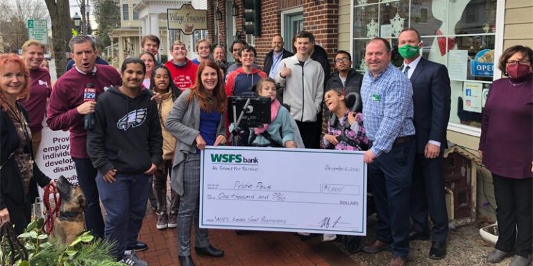 Pride Paws staff and WSFS Associates holding a prop check for $1000.
