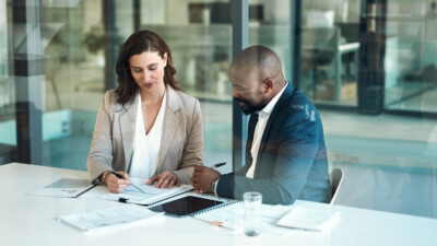 A private banker reviewing mortgage documents with their client.