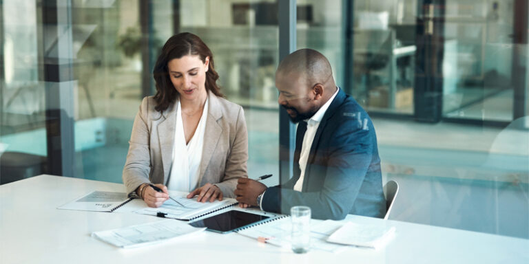 A private banker reviewing mortgage documents with their client.