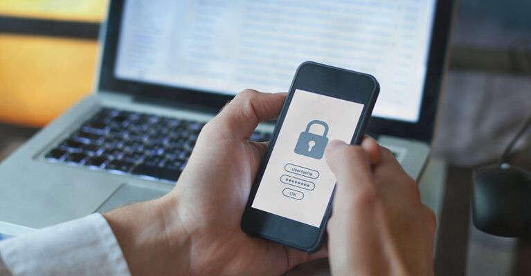 A man logging in to a website on his cell phone.