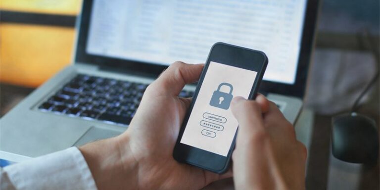 A man logging in to a website on his cell phone.