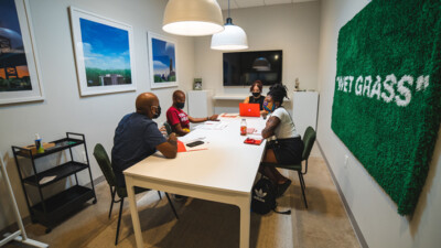 Artists talking at a table in REC Philly.