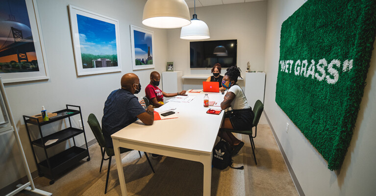 Artists talking at a table in REC Philly.