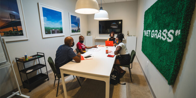 Artists talking at a table in REC Philly.