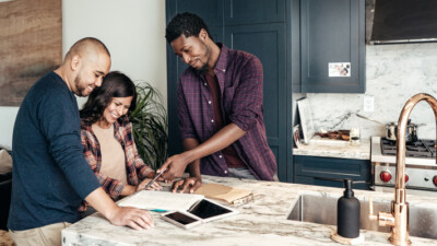 A couple reviewing housing information with their realtor.