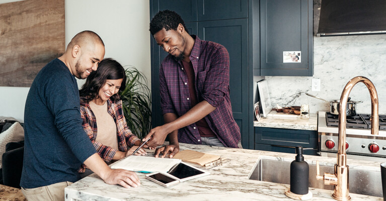 A couple reviewing housing information with their realtor.