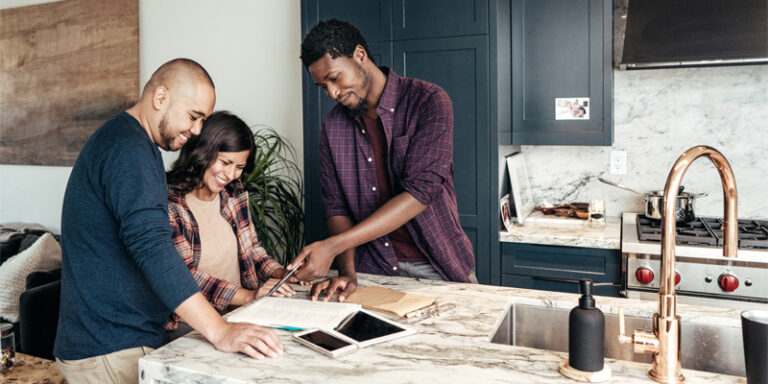 A couple reviewing housing information with their realtor.