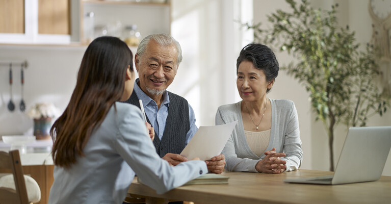 A couple discussing finances with their adviser.