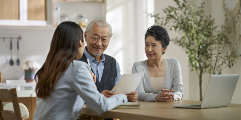 A couple discussing finances with their adviser.