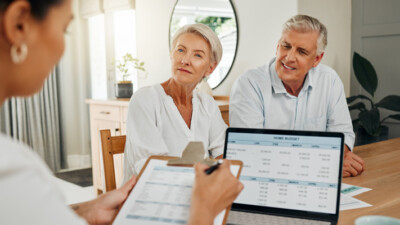 A couple discussing a reverse mortgage with their lender.