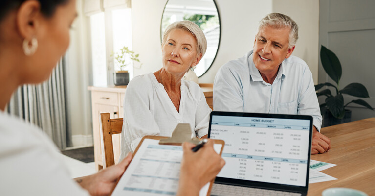 A couple discussing a reverse mortgage with their lender.