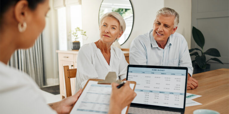 A couple discussing a reverse mortgage with their lender.