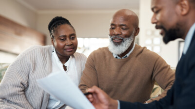 A couple reviewing their finances with their financial advisor.