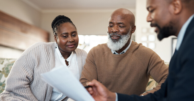 A couple reviewing their finances with their financial advisor.