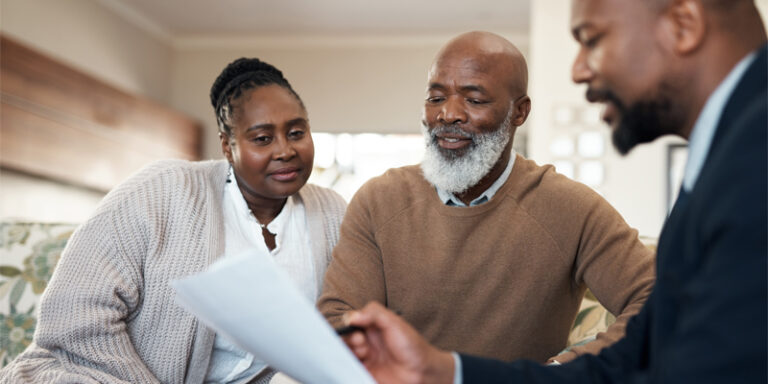 A couple reviewing their finances with their financial advisor.