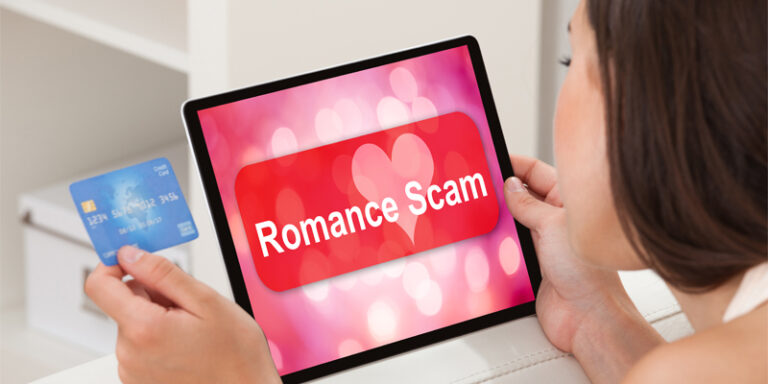 A person looking at their credit card and a tablet that says, “romance scam.”