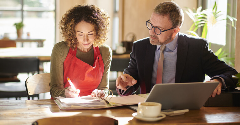 A small business owner working with their banker.