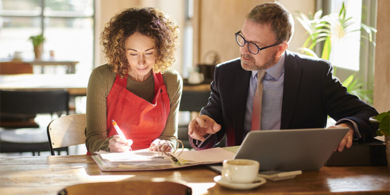 A small business owner working with their banker.