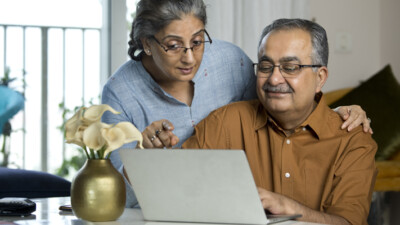 A couple looking at a laptop.