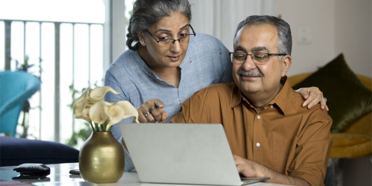 A couple looking at a laptop.
