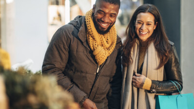 A couple smiling and shopping.