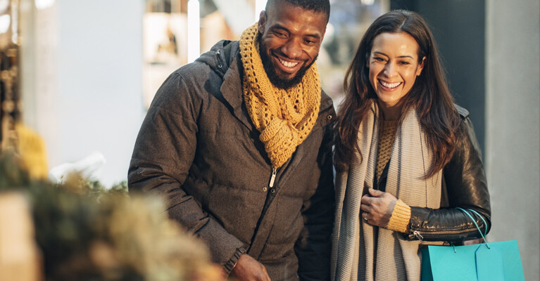 A couple smiling and shopping.