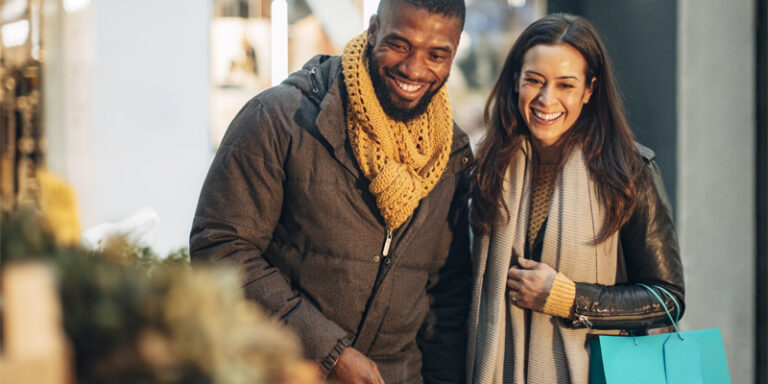 A couple smiling and shopping.
