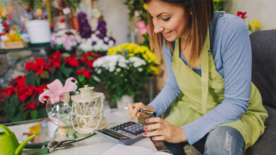 A flower shop owner reviewing the business’ finances.
