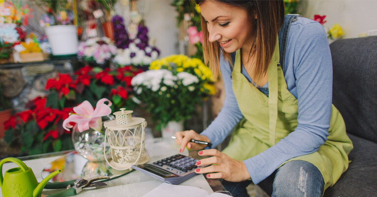 A flower shop owner reviewing the business’ finances.