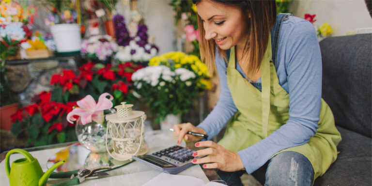 A flower shop owner reviewing the business’ finances.
