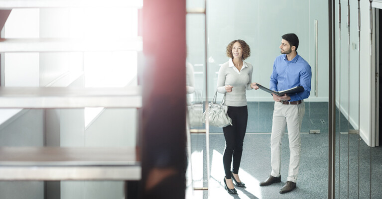 A real estate agent showing a woman a property.
