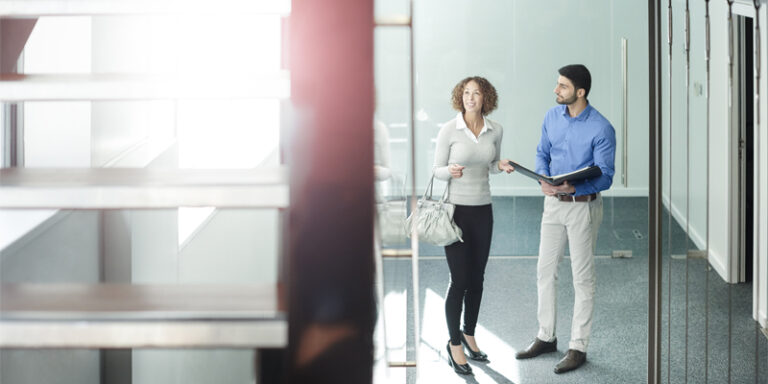 A real estate agent showing a woman a property.