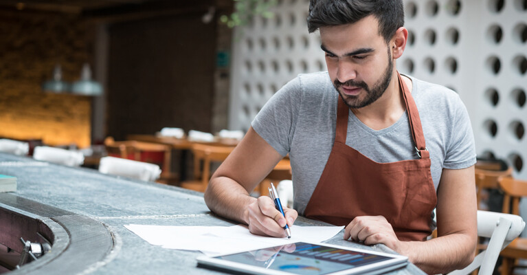 A small business owner reviewing expenses.