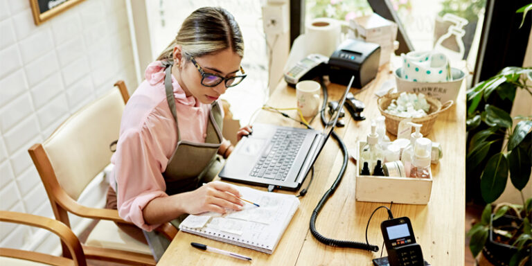 A female business owner working on the company’s finances.