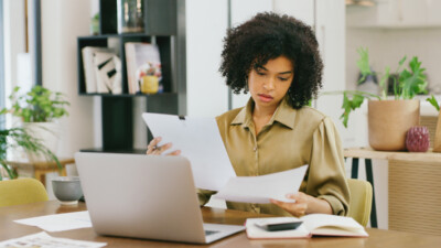 A woman reviewing papers.