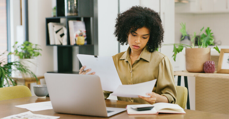 A woman reviewing papers.