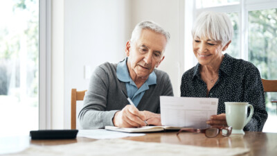 An elderly couple working on their finances.