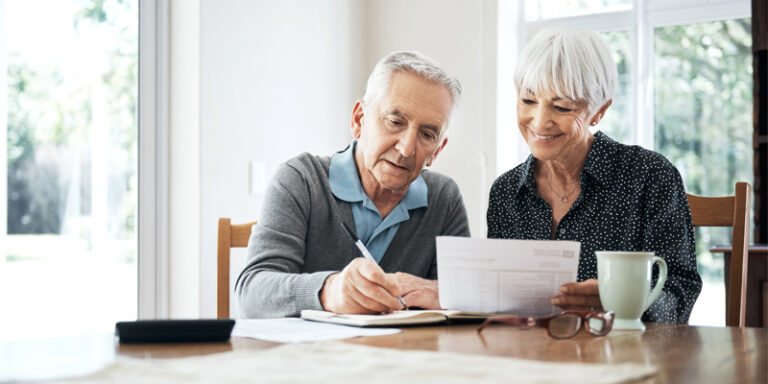 An elderly couple working on their finances.