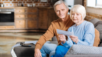 An elderly couple looking at their social security check.