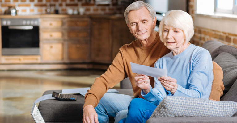 An elderly couple looking at their social security check.