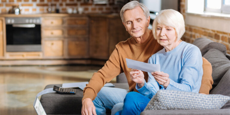 An elderly couple looking at their social security check.