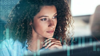 A woman looking at stock charts.