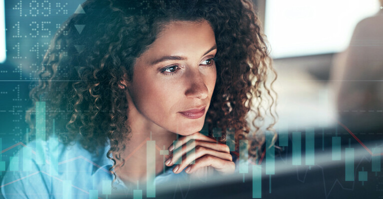 A woman looking at stock charts.